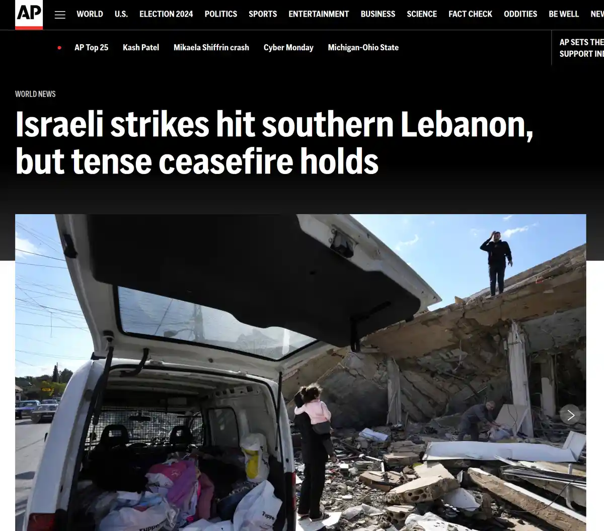 A screenshot of an Associated Press news article shows a photo of people amidst rubble from destroyed buildings, with a…