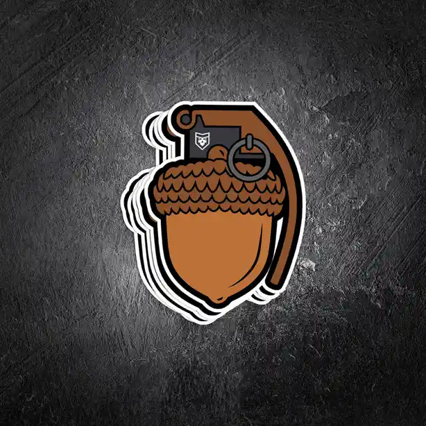 A stack of stickers shows a cartoon acorn with a grenade pin and safety lever replacing its cap, featuring a small black…