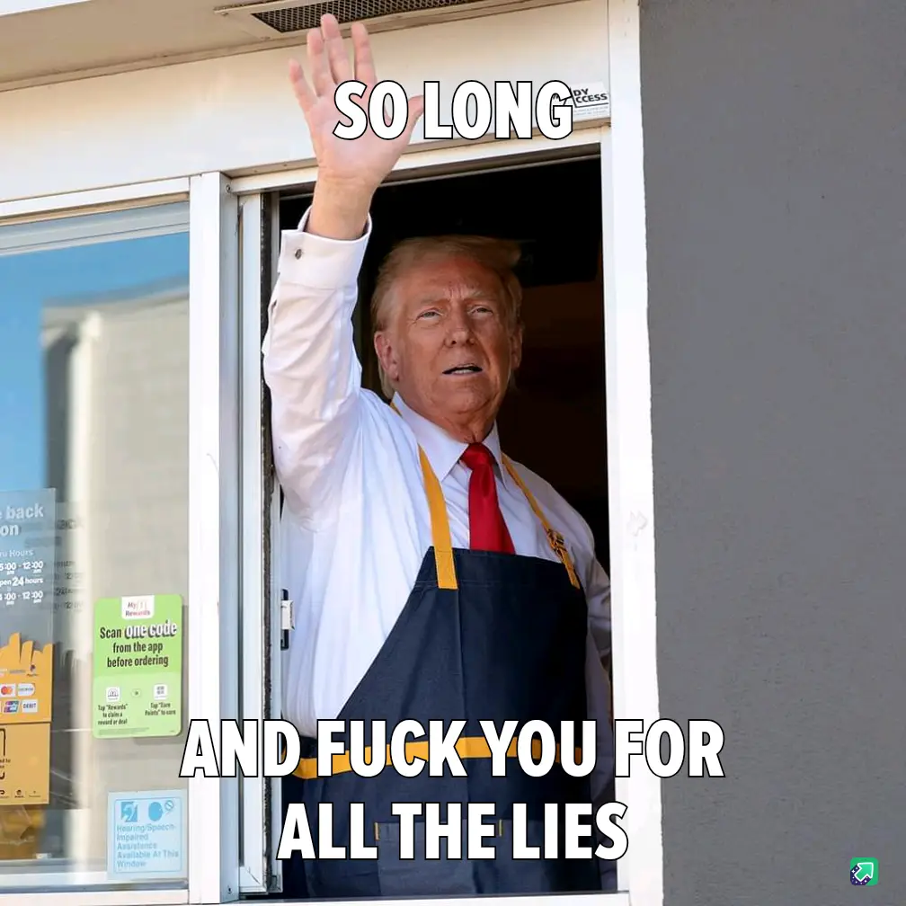 A man with blond hair wearing a white shirt, red tie, and dark blue apron with yellow straps is waving from a drive-thru…