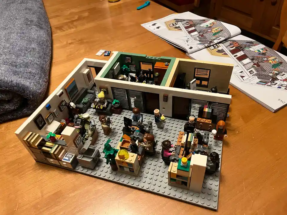 A detailed LEGO model of the office from 'The Office' TV show, featuring miniature LEGO figures in their desks and…