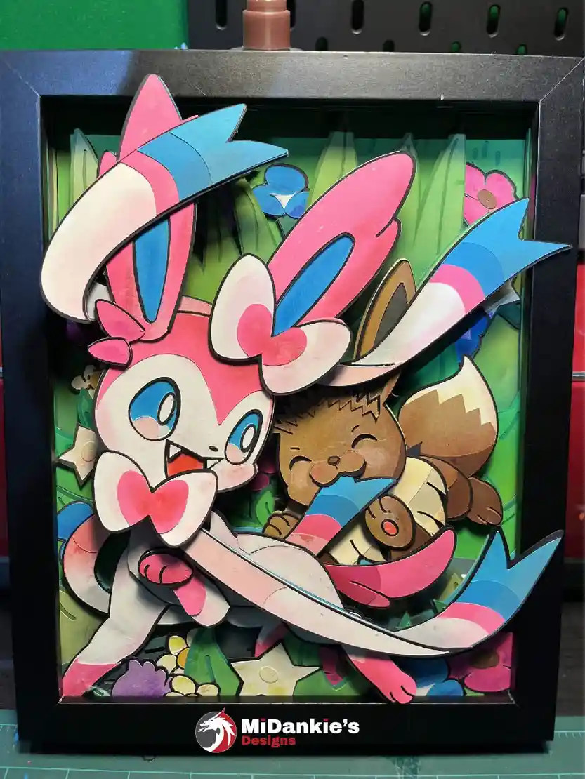 A charming shadow box featuring Sylveon and Eevee!