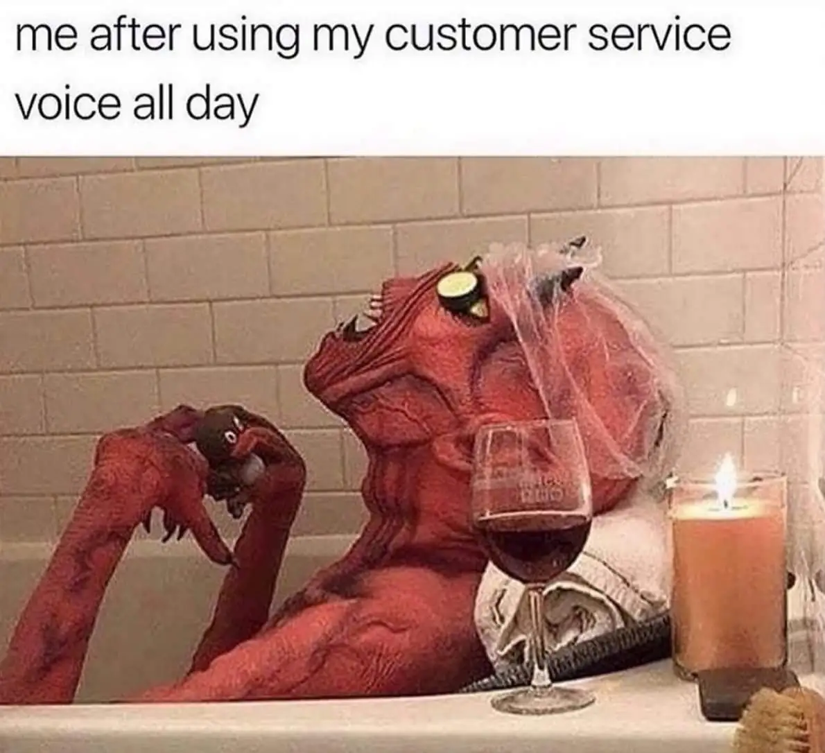 A red-skinned, demonic-looking creature with a veil sits in a bathtub, holding a small plush toy, next to a glass of red…