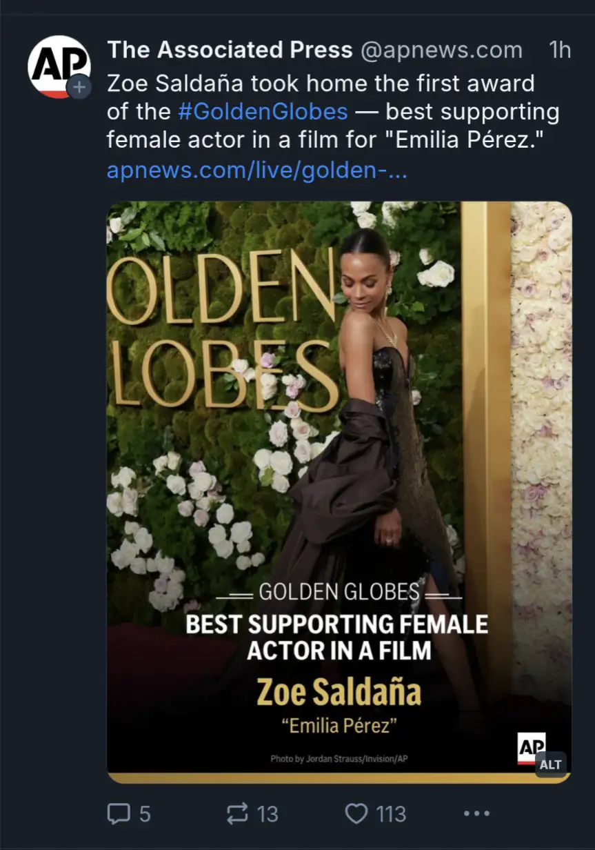 A screenshot of an Associated Press tweet showing a photo of actress Zoe Saldaña at the Golden Globes. She is wearing a…