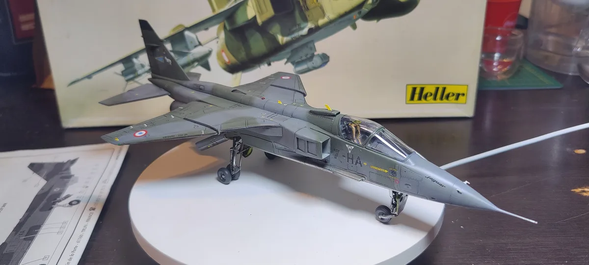 A highly detailed grey model of a Dassault Mirage 2000 fighter jet, marked with French roundel and 'Jaguar' on the nose…