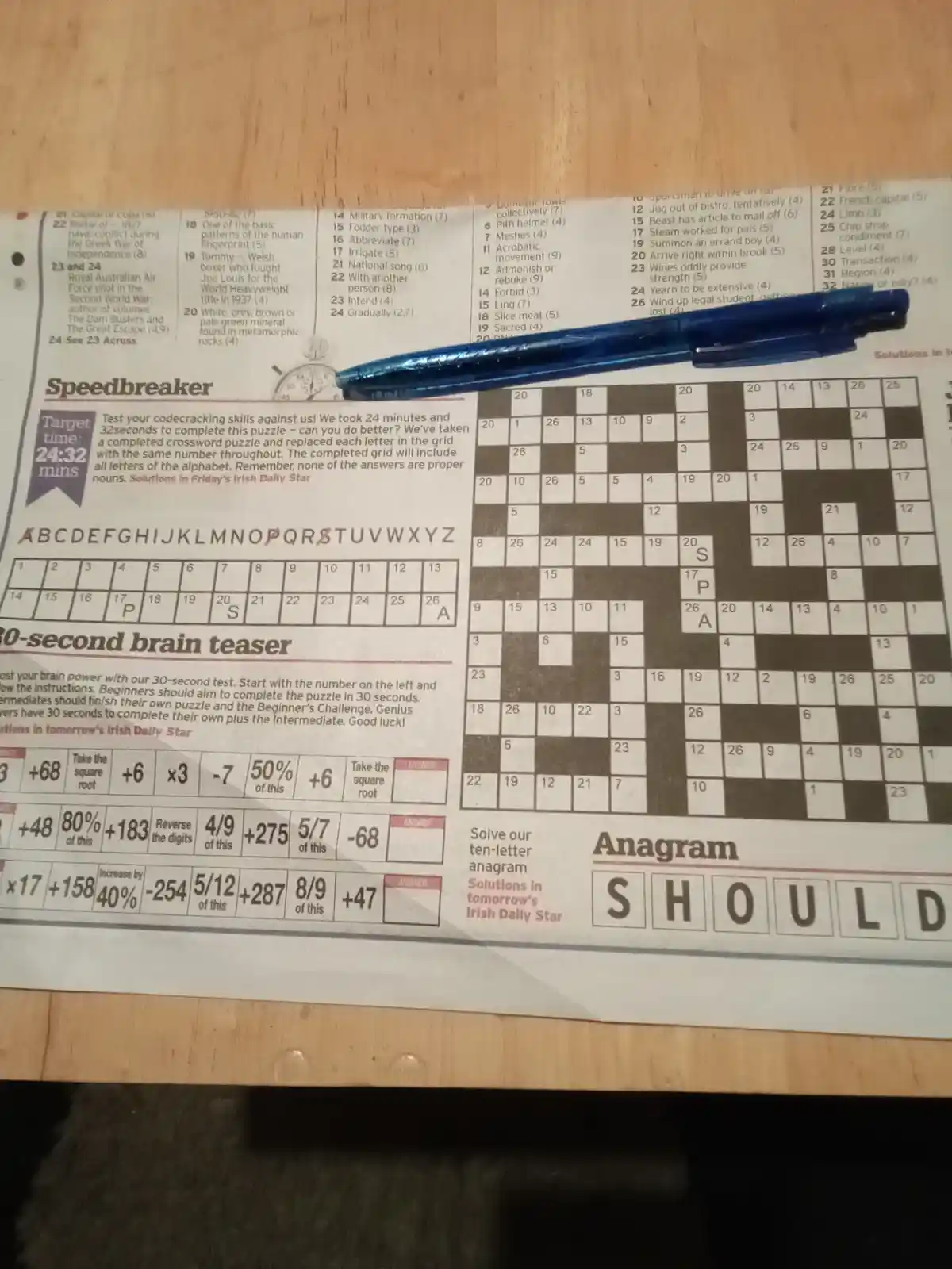 A newspaper page with a 'Speedbreaker' crossword puzzle where letters are replaced with numbers, a '30-second brain teaser'…