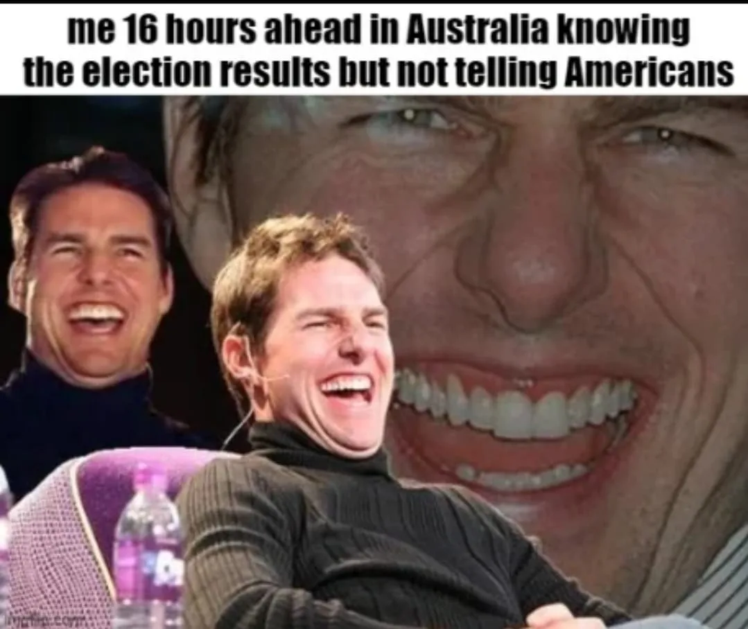 The image features actor Tom Cruise in a black turtleneck, laughing heartily while seated. Behind him, a large, distorted…
