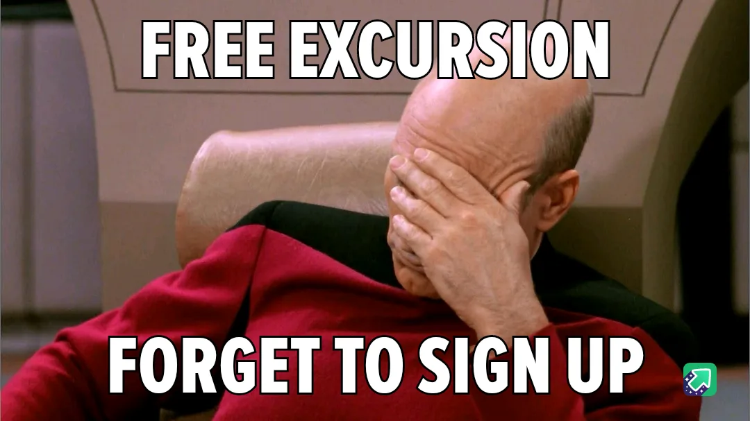 A bald man in a red uniform sits in a chair, covering his face with his hand in a gesture of despair or embarrassment. The…