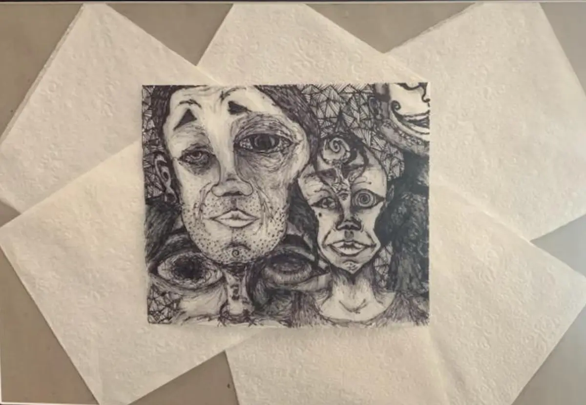 A black-and-white ink drawing on paper depicts two surreal, distorted human faces with exaggerated eyes and abstract…