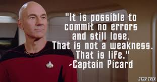A still image of Captain Jean-Luc Picard from Star Trek: The Next Generation, wearing his red command uniform and looking…