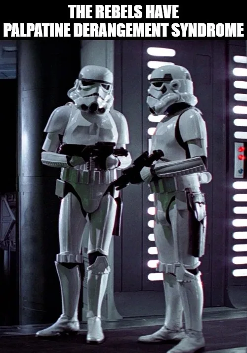 Two stormtroopers stand facing each other in a dimly lit corridor with glowing panels on the wall behind them. One trooper…