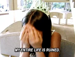 A woman wearing a tiara sits on a bench, progressively revealing her despair as she covers her face with her hands in each…
