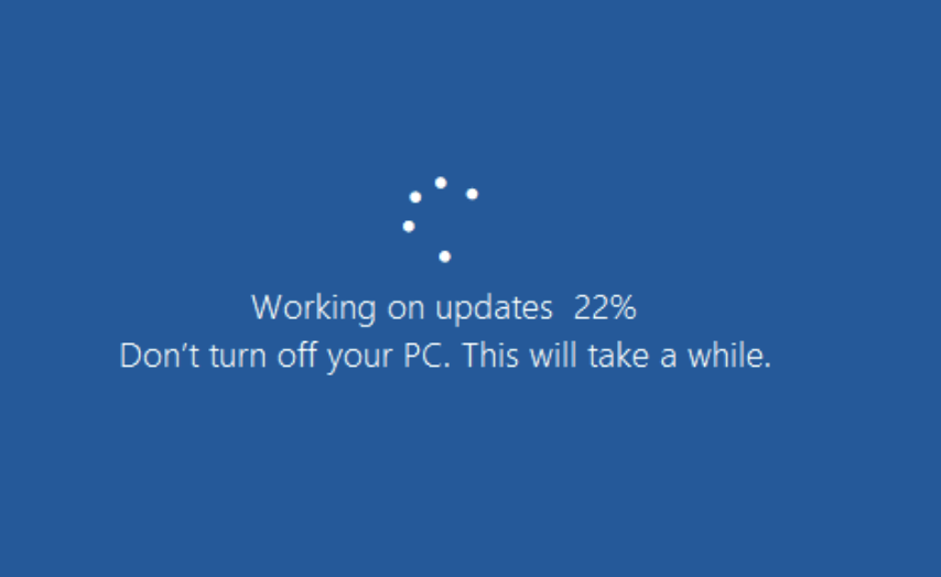 A blue screen with a white loading spinner and text stating 'Working on updates 22% Don't turn off your PC. This will take a…