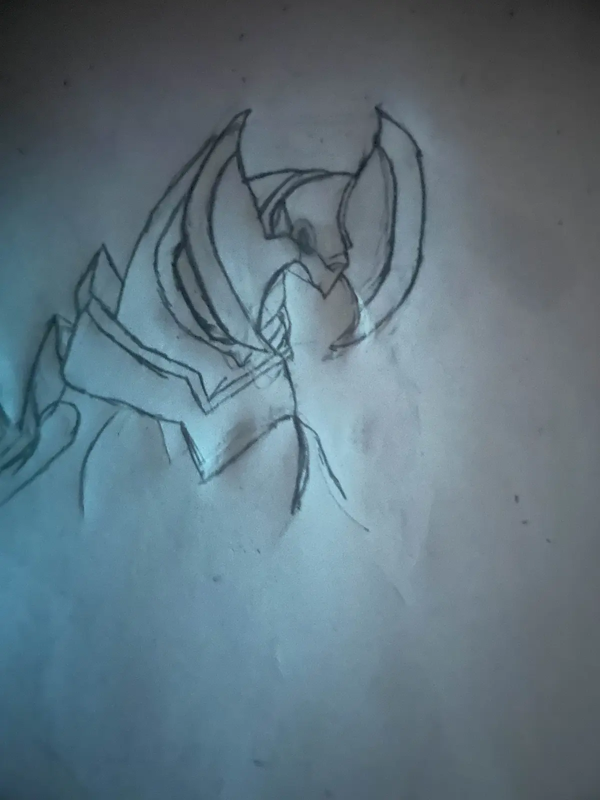 A rough pencil sketch on paper shows a stylized, angular character with large, pointed ears or horns and a sharp, angular…
