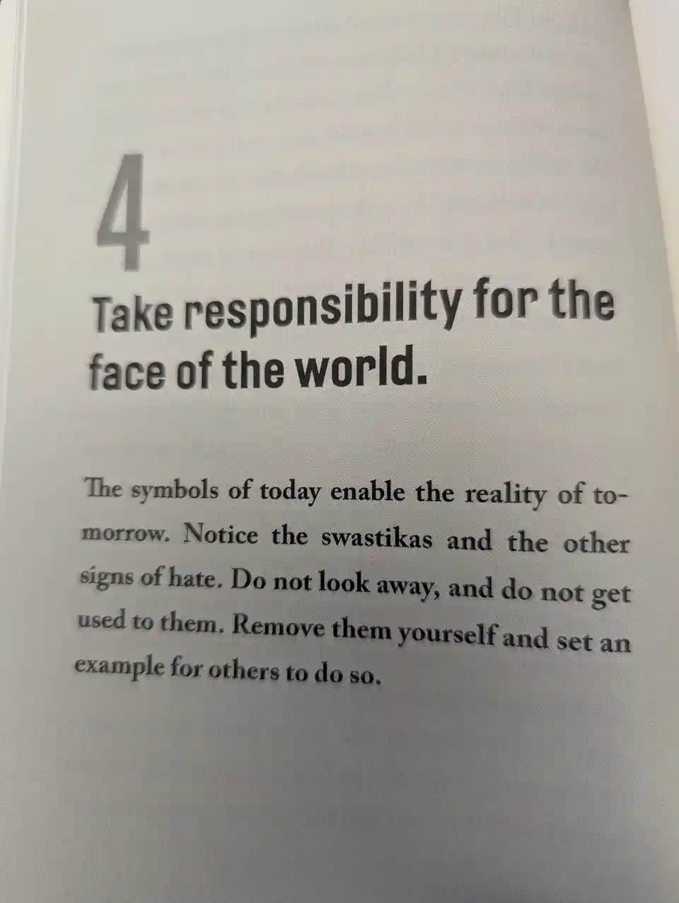 A close-up of a printed page showing point number 4, which reads 'Take responsibility for the face of the world.' The…