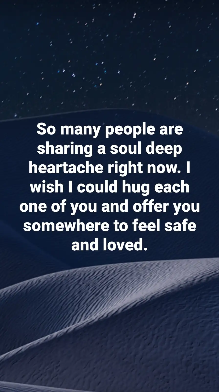 The image shows a dark, starry night sky above textured, rolling dunes under a deep blue hue. Centered over the dunes is…