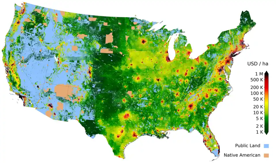 A heat map of the United States showing land values in USD per hectare, with a color scale from dark green (low value…