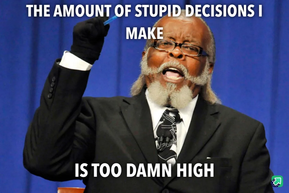 A man in a black suit and glasses, holding a pen in his gloved hand, looks frustrated while standing in front of a blue…