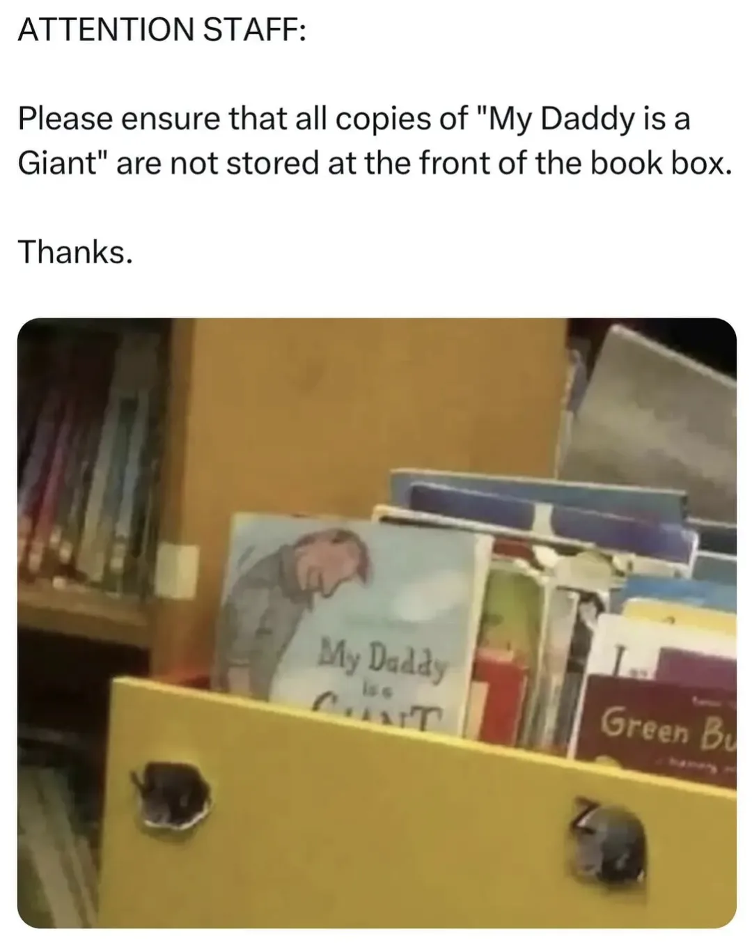 A yellow book box in a library or bookstore has a copy of the children's book 'My Daddy is a Giant' prominently displayed at…