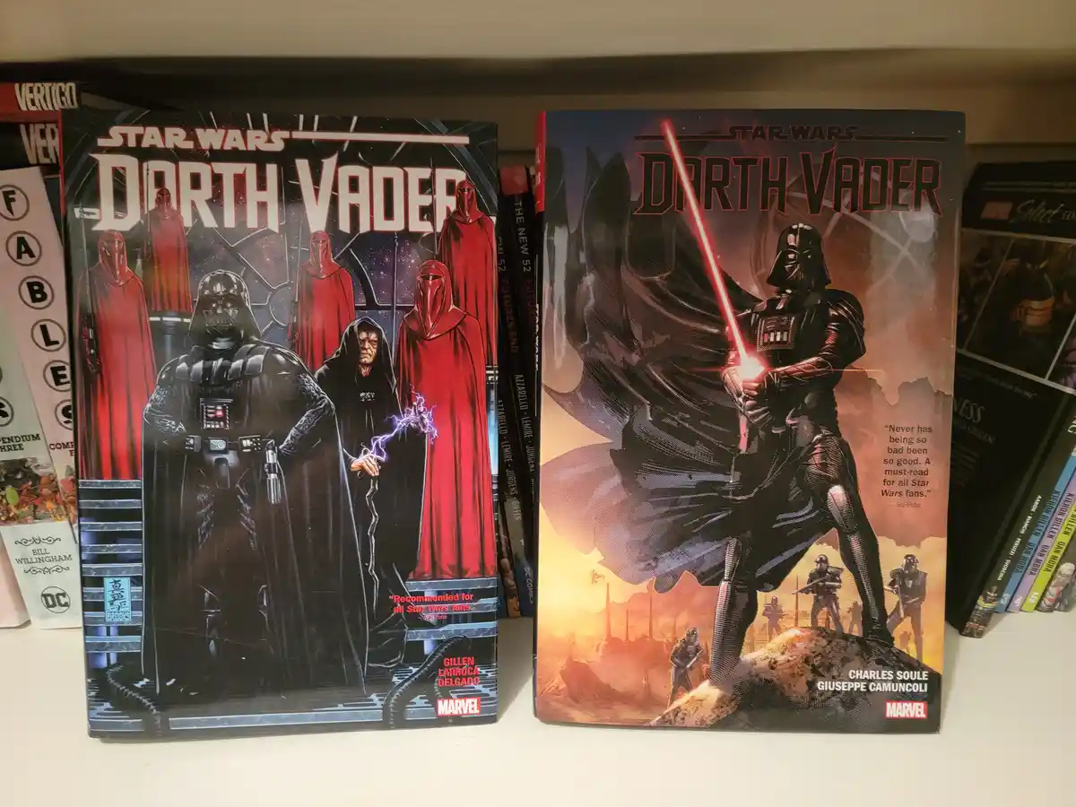 Two Star Wars Darth Vader comic books sit side-by-side on a shelf. The left cover shows Darth Vader and Emperor Palpatine…