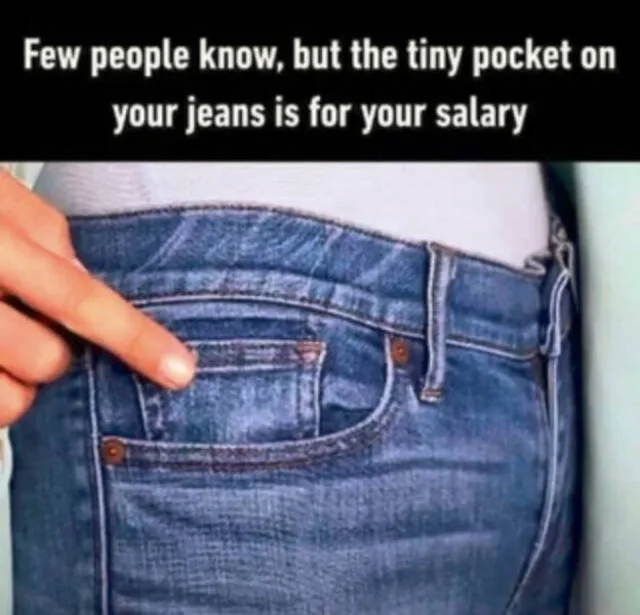 A close-up image shows a person's hand pointing to the small coin pocket on the back right side of a pair of blue denim…