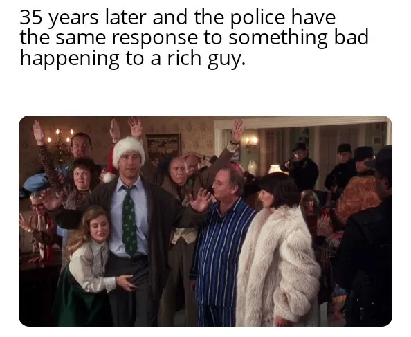 A still from the movie 'The Godfather' shows a group of people, including a man in a Santa hat and another in striped…