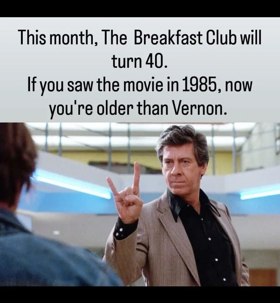 A still from the movie 'The Breakfast Club' shows actor Judd Nelson as Vernon, making a peace sign with a serious expression…