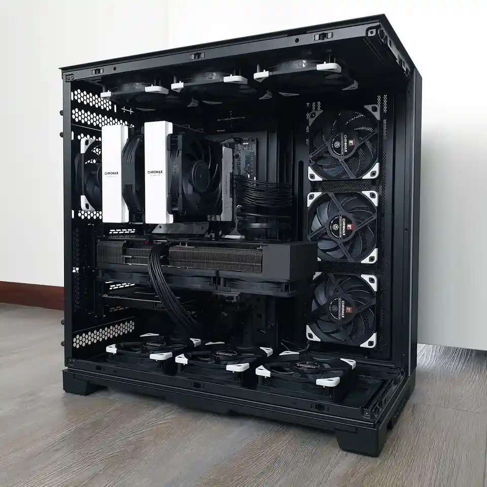 A black computer case with its side panel removed, revealing an extreme overcooling setup with multiple white and black…