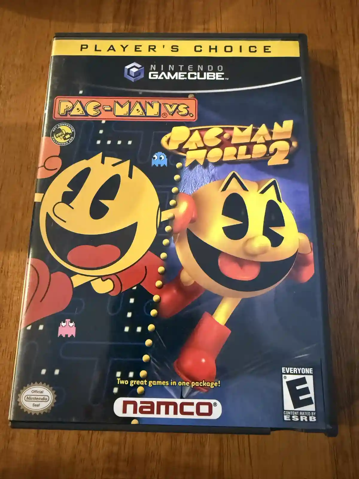 A Nintendo GameCube game case for 'Pac-Man vs. Pac-Man World 2' shows two versions of Pac-Man, one classic 2D and one 3D…