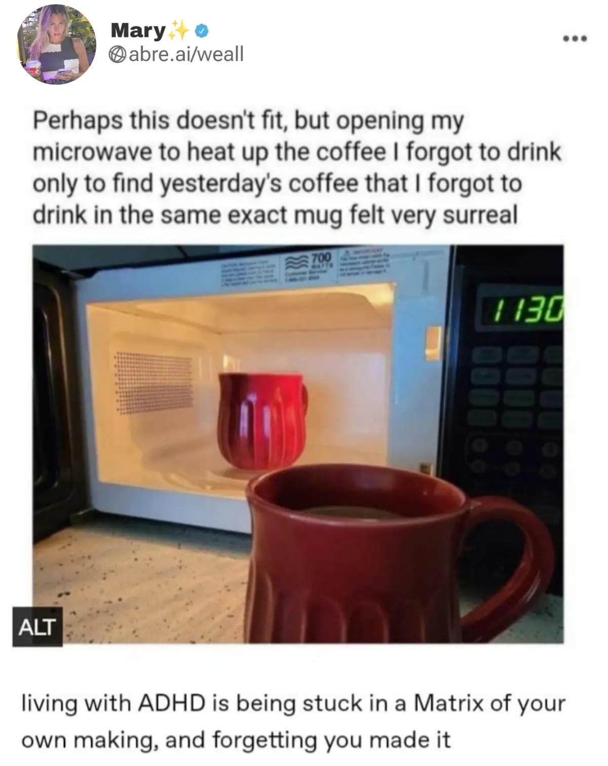 A photo shows an open microwave with a red mug inside, and another identical red mug sits in front of it on a speckled…