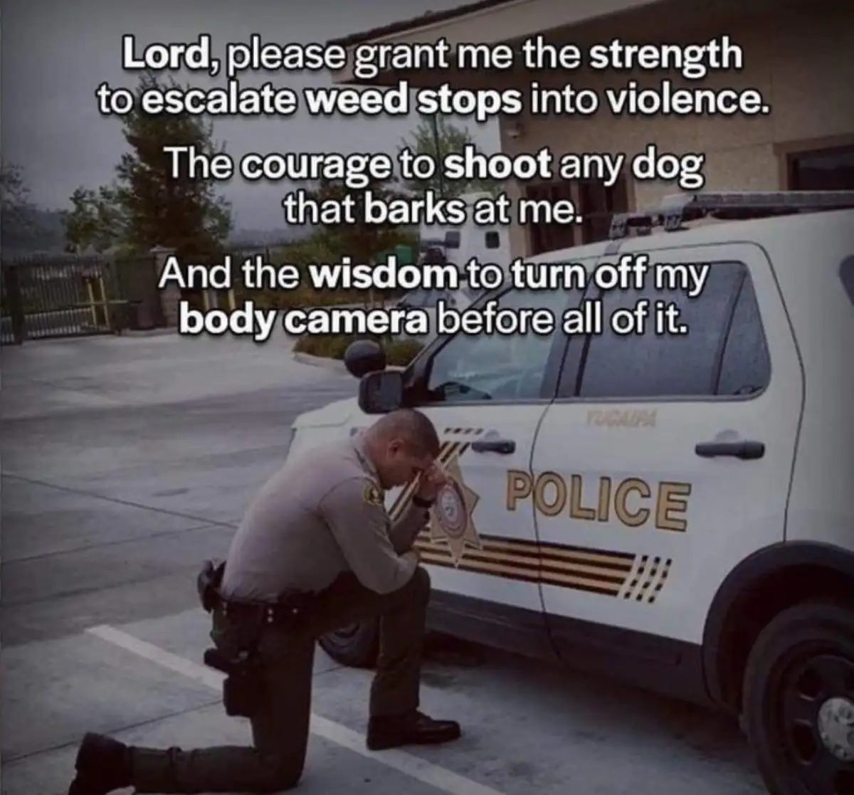 A police officer in uniform is kneeling on one knee beside a white police cruiser with 'POLICE' and 'YUCAIPA' visible on the…