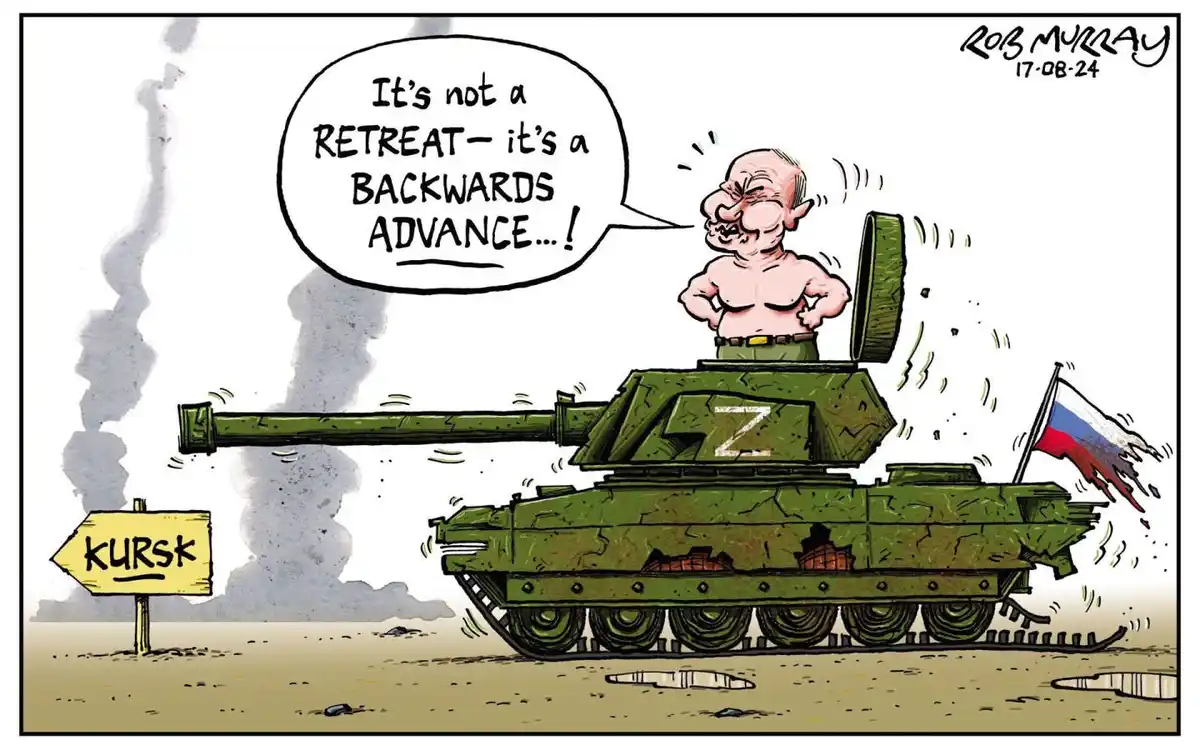 A cartoon depicts a caricatured bald man with a large nose and angry expression standing shirtless atop a green tank marked…