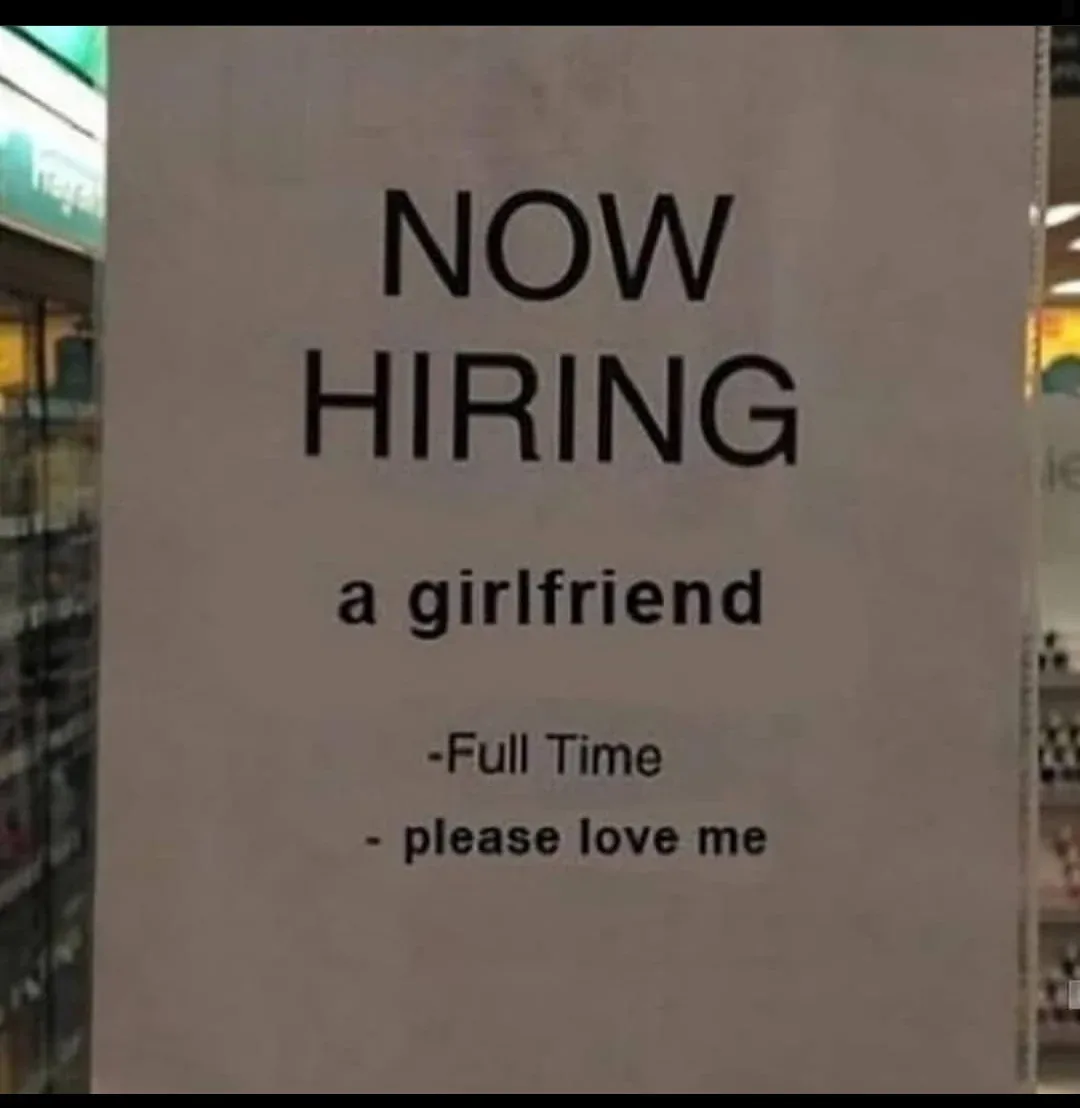 A photograph of a white paper sign in a store aisle, mimicking a job advertisement. The text reads 'NOW HIRING a…