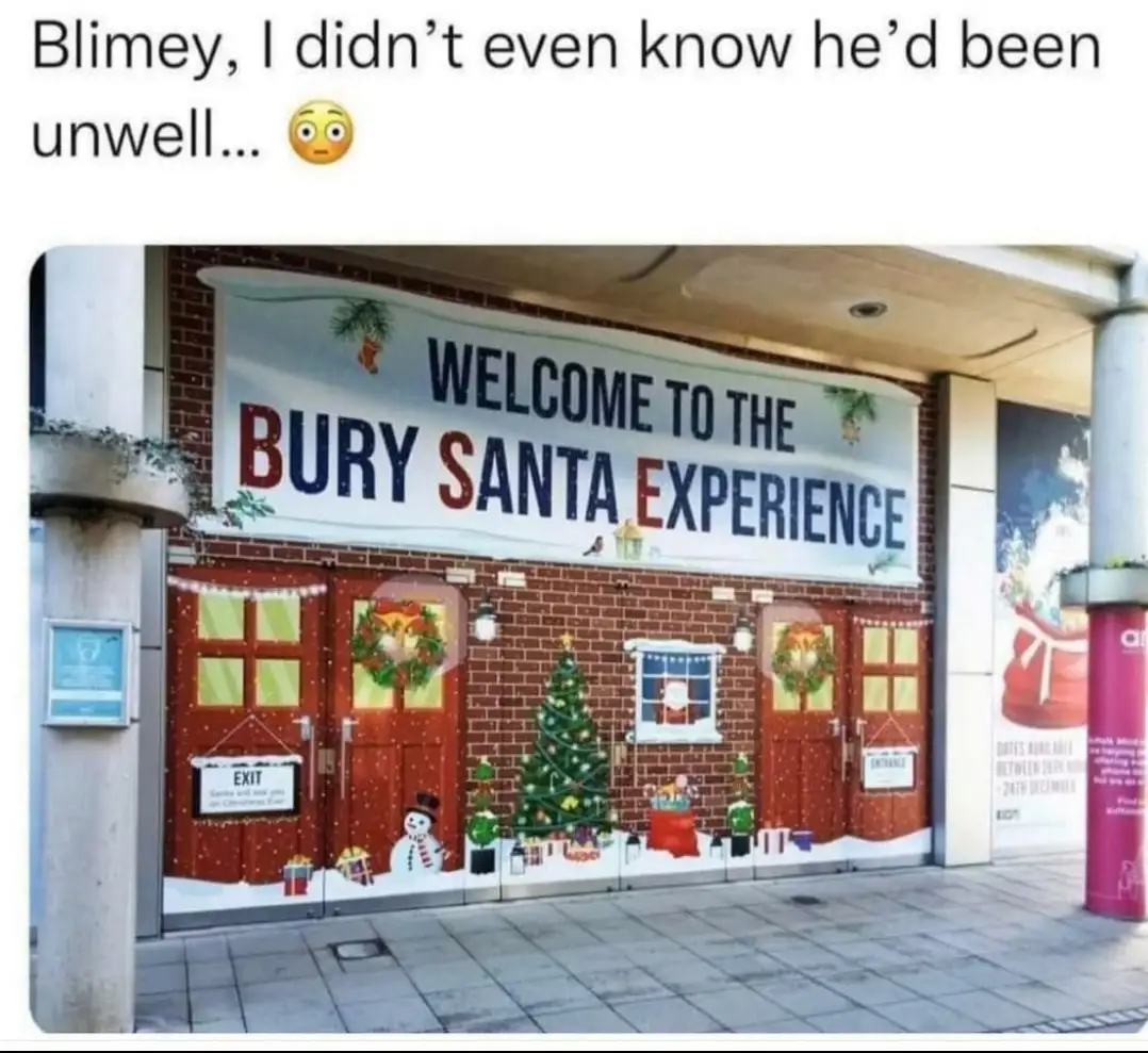 A photo of a storefront decorated for Christmas with a large banner reading 'WELCOME TO THE BURY SANTA EXPERIENCE'. The…