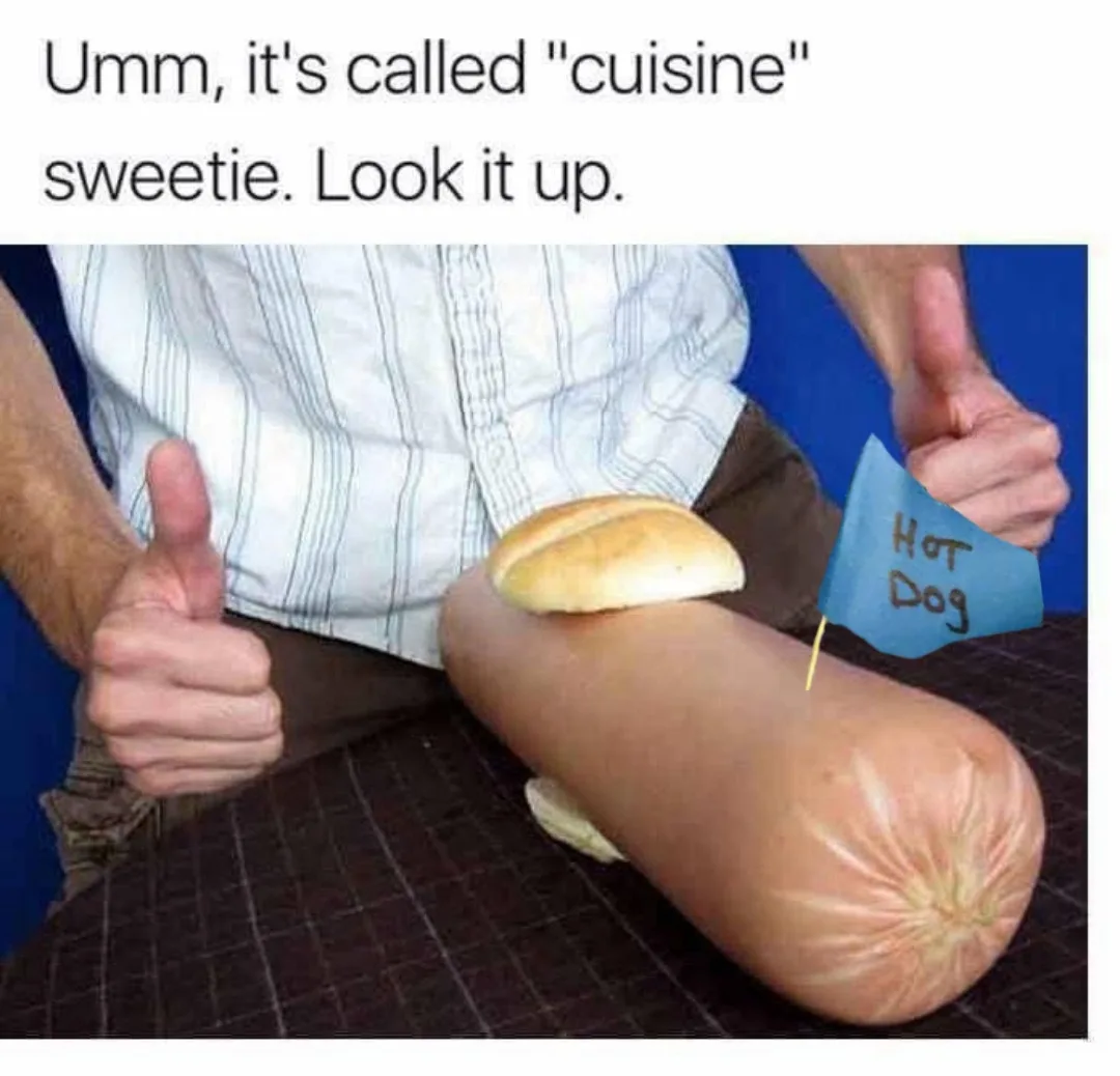A person wearing a striped shirt gives two thumbs up while sitting with a hot dog bun placed on their thigh, which is…