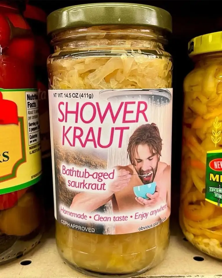 A jar of sauerkraut on a grocery store shelf has a humorous label that reads 'SHOWER KRAUT', 'Bathtub-aged saurkraut'…