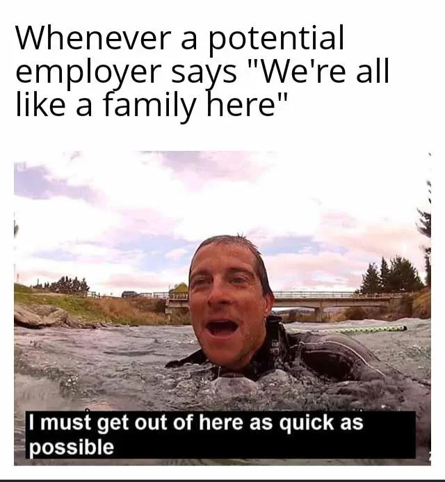A man in a wetsuit is partially submerged in a river, looking upward with a shocked or horrified expression. The sky is…