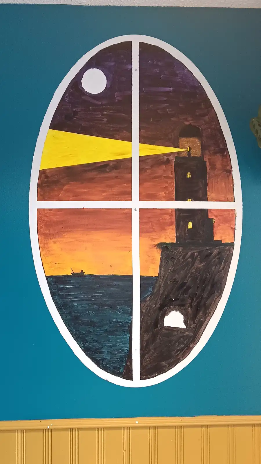 A hand-painted mural on a teal wall depicts a large oval divided into four quadrants, resembling the Death Star from Star…