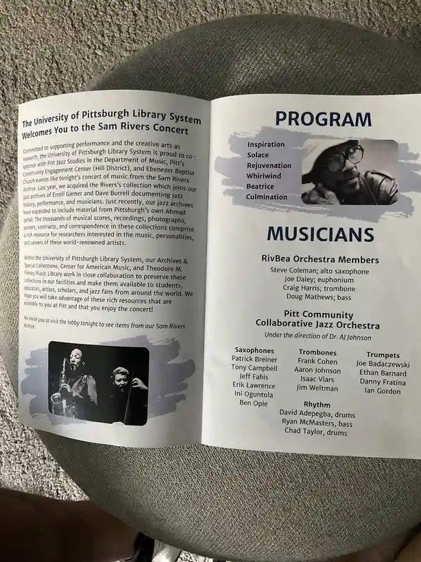 A printed concert program for a Sam Rivers jazz event at the University of Pittsburgh Library System, resting on a gray…