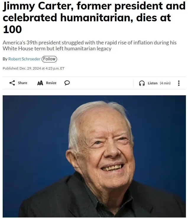 A screenshot of a news article headline announcing the death of Jimmy Carter at age 100, featuring a photo of the smiling…