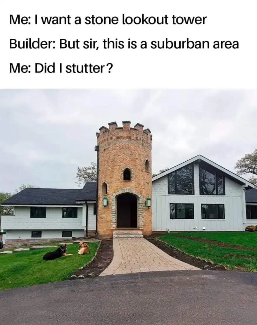 A photo of a modern suburban house with a prominent, medieval-style brick tower attached to its front. Two dogs lie on the…