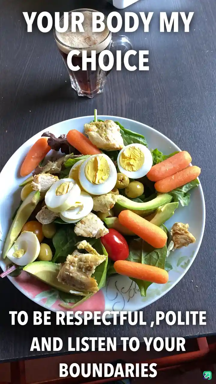 A photo of a healthy salad with chicken, boiled eggs, avocado, cherry tomatoes, and baby carrots on a white plate, next to a…