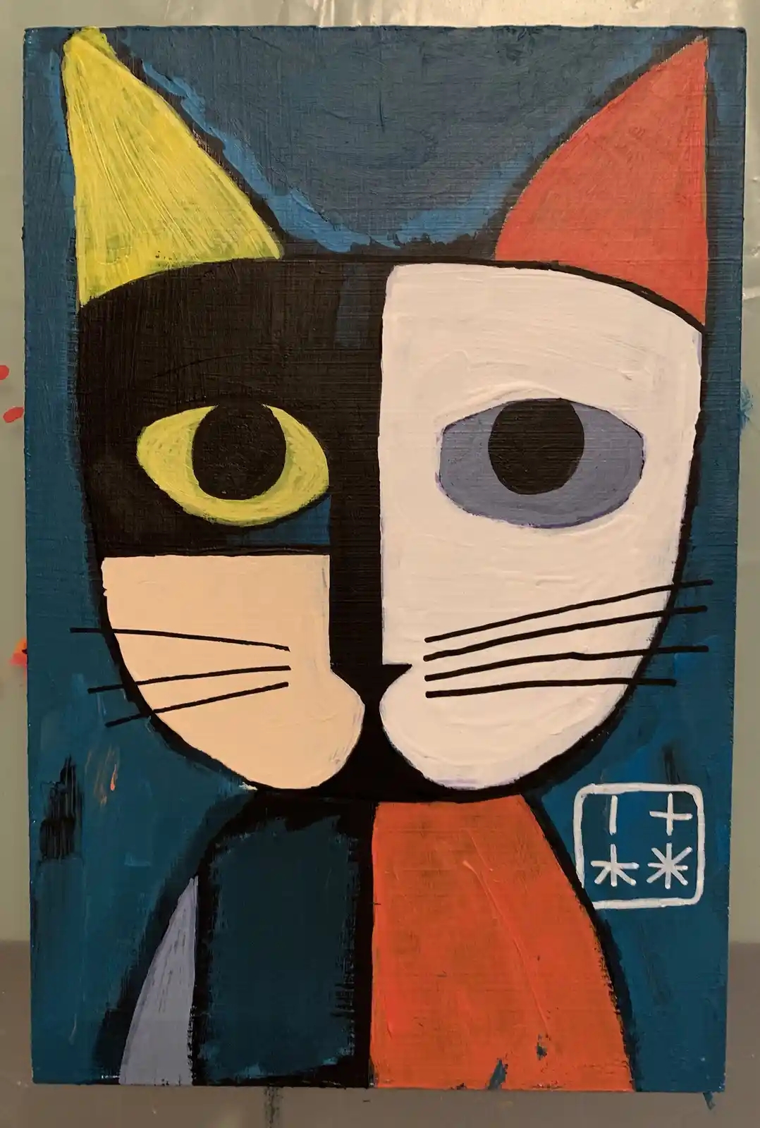 A painted portrait of a cat split vertically down the middle, with one half black and one half white, each with different…