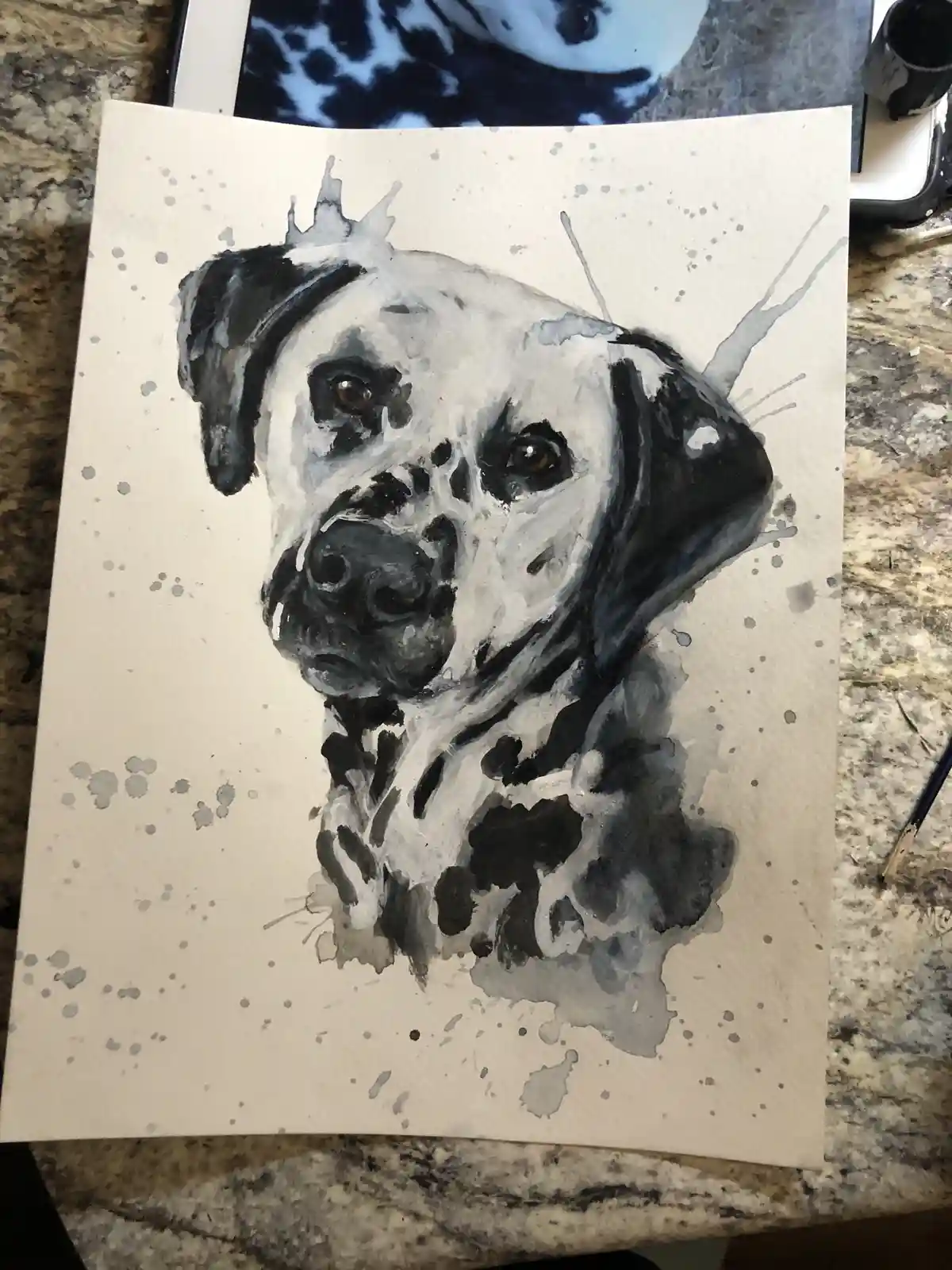 A watercolor painting of a Dalmatian dog on textured paper, featuring black and white splatters around the portrait. The dog…
