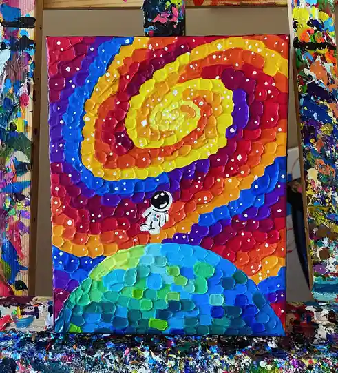 A textured, thickly painted canvas depicts a small white astronaut floating above a colorful, rainbow-hued planet. The…