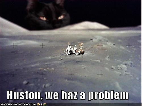 A black cat with glowing orange eyes peers menacingly from behind the lunar surface, overlooking a tiny Apollo lunar module…