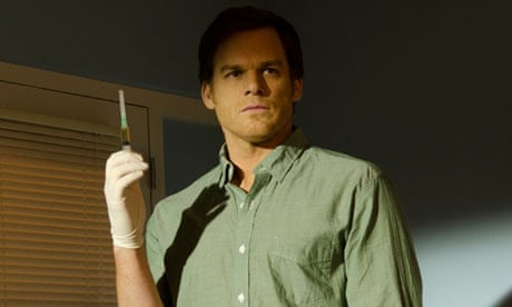 a man in a green button-down shirt and white glove holds a syringe filled with green liquid, looking serious under dramatic…