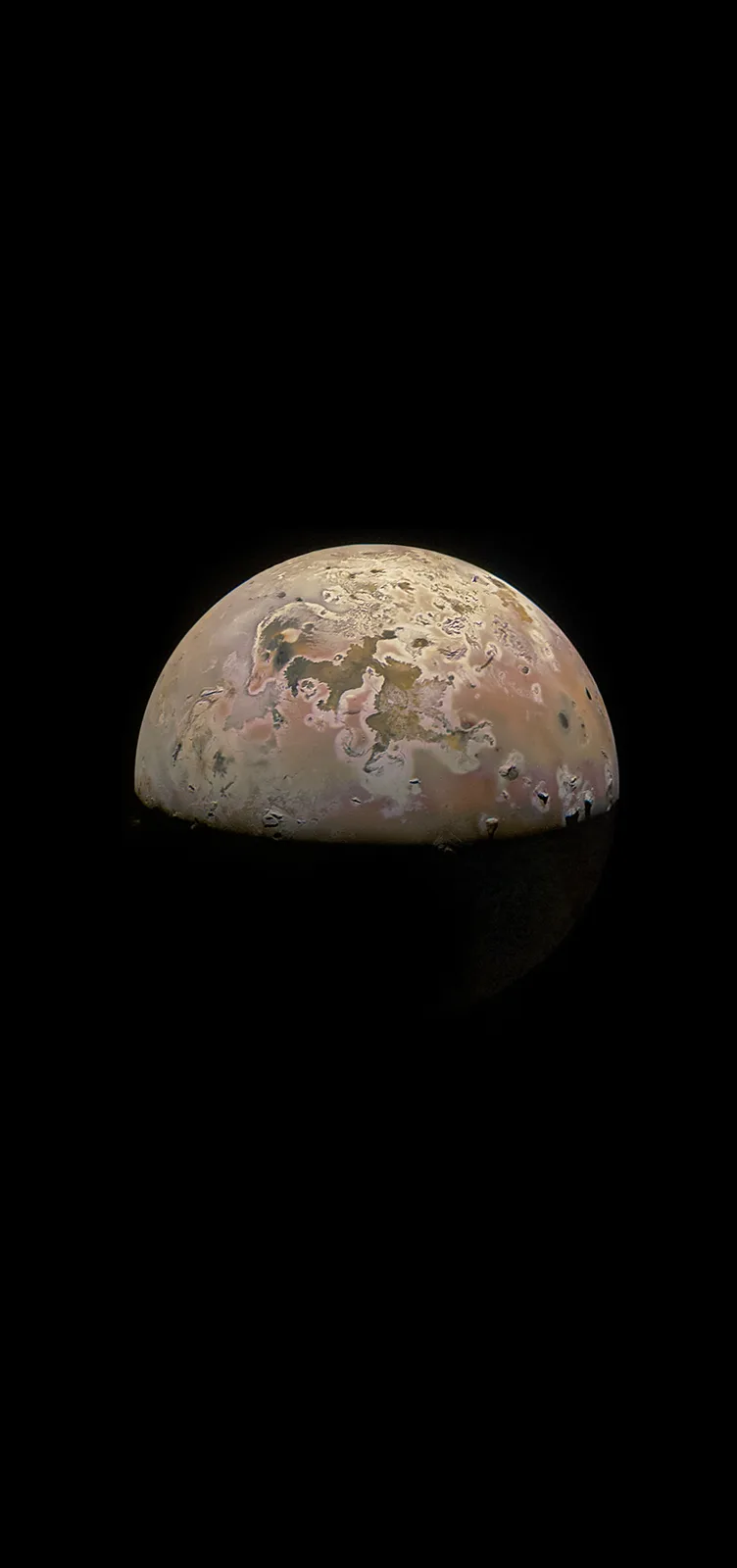 A high-resolution image of Pluto, showing its varied surface with shades of pink, tan, and brown against a black space…