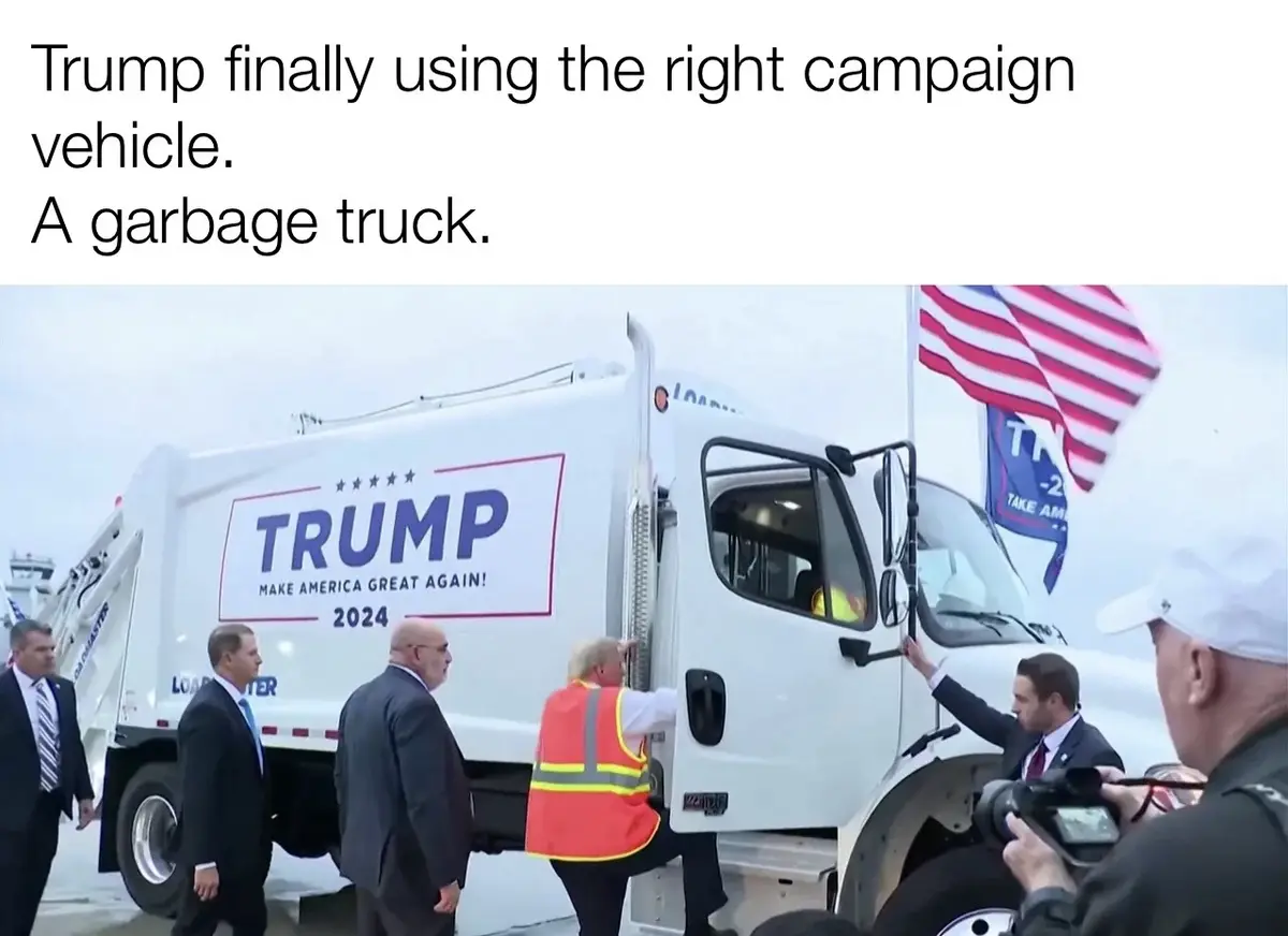 A white garbage truck is modified with a large 'TRUMP MAKE AMERICA GREAT AGAIN! 2024' campaign sign on its side. A man in an…