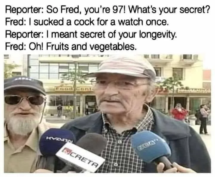 An elderly man with glasses and a cap is being interviewed by reporters holding microphones from 'CRETA' and 'NEN' news…