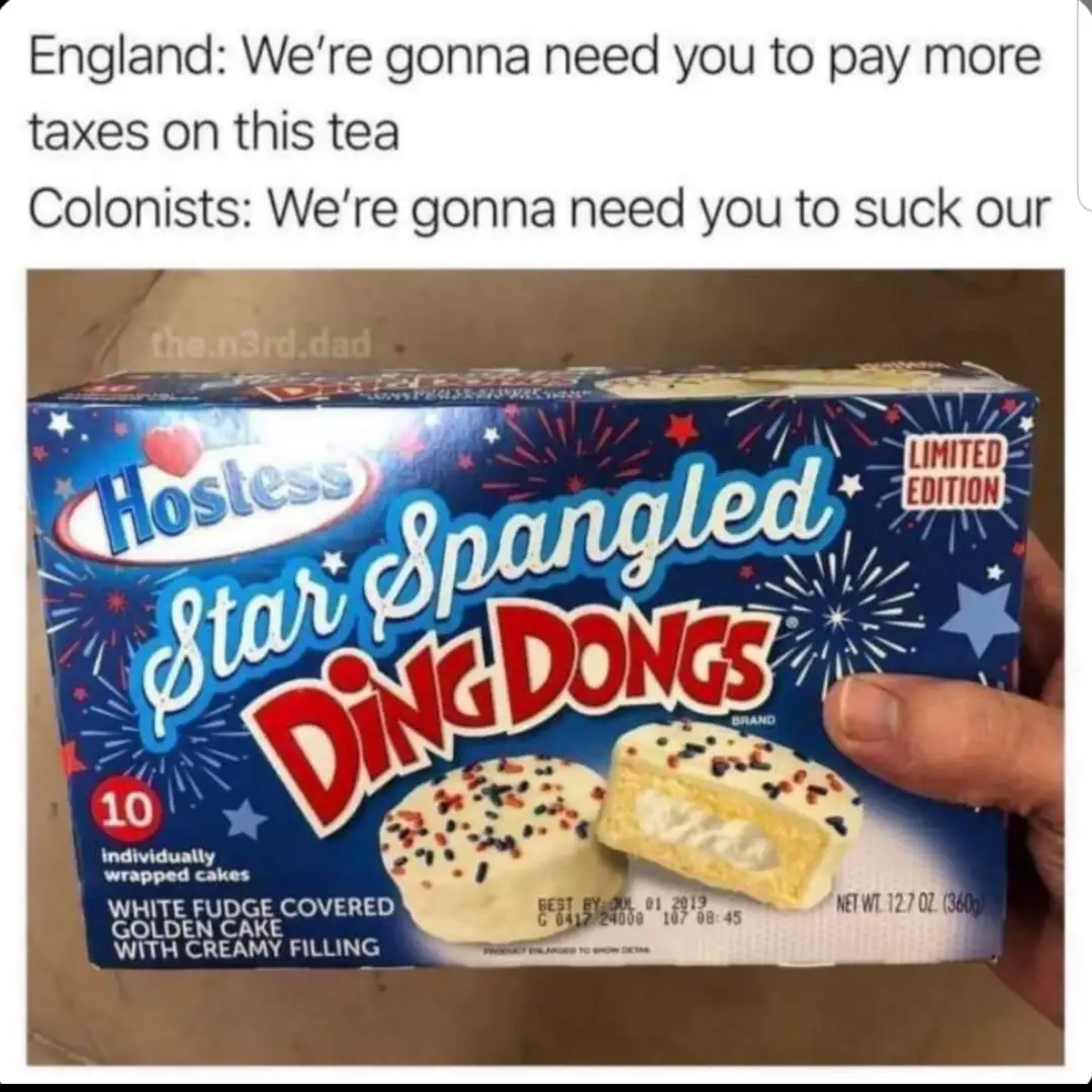 A hand holds a blue box of Hostess Star Spangled Ding Dongs, a limited edition snack cake with white fudge and creamy…
